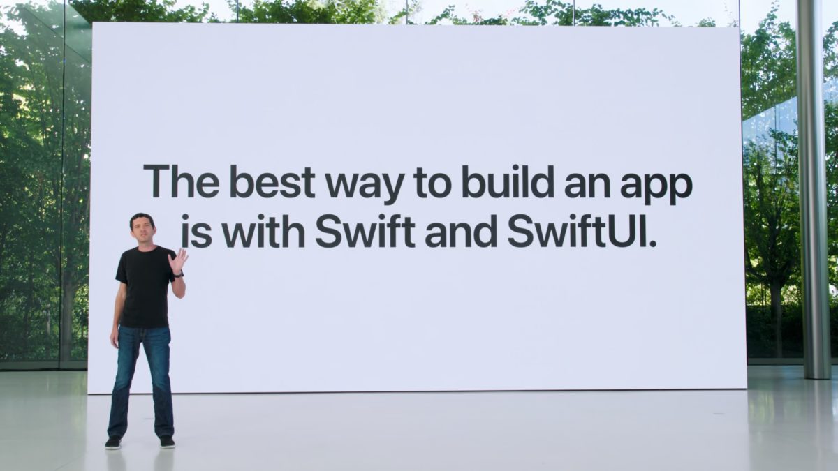 Josh Shaffer standing in front of a large slide that says "The best way to build an app is with Swift and Swift UI"